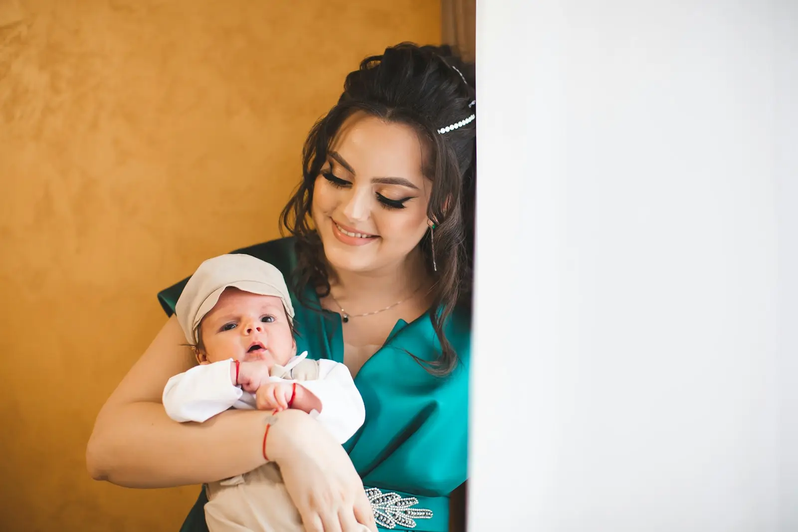 A mother gently holding her newborn baby