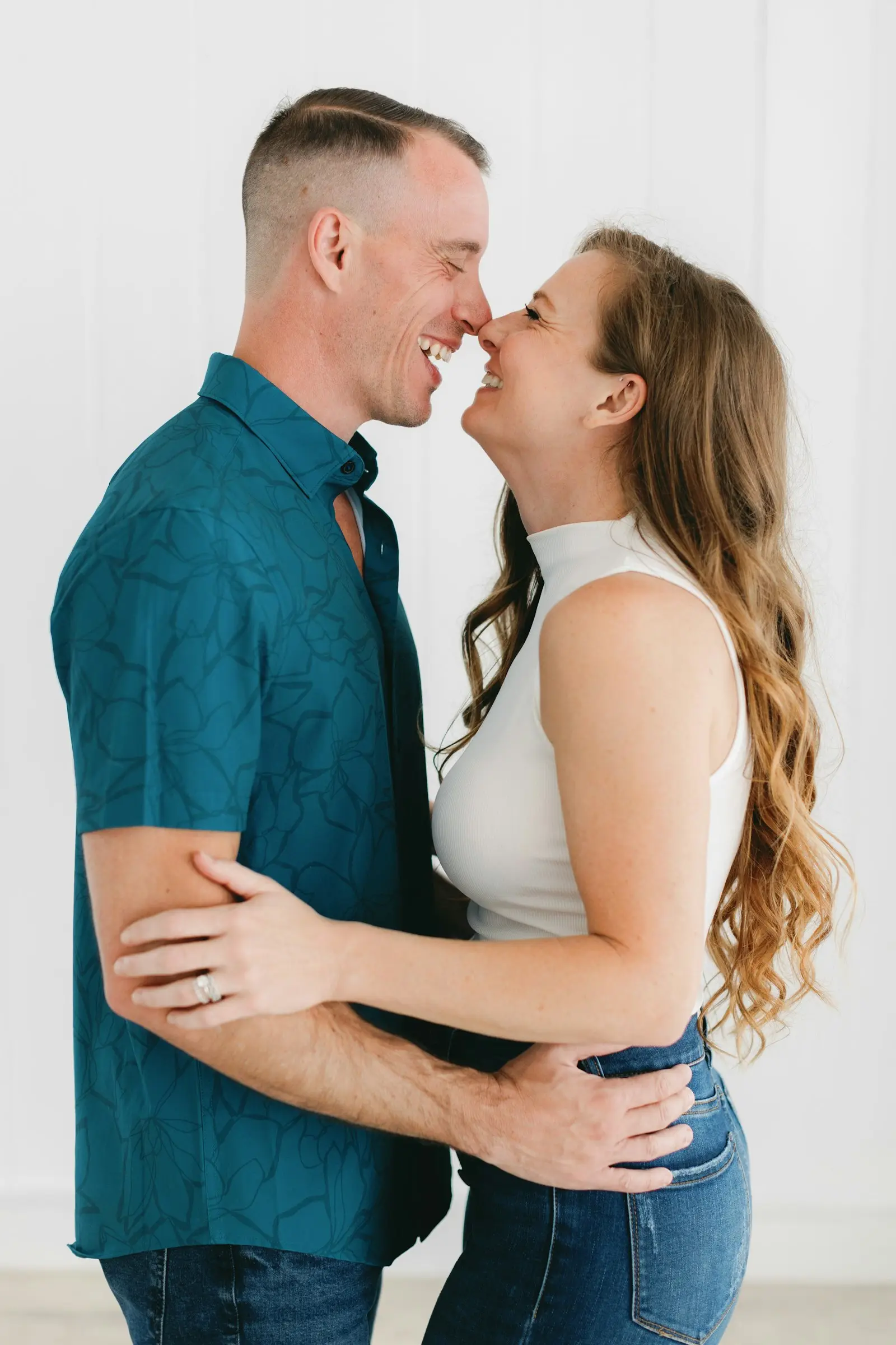 A happy couple laughing together at home